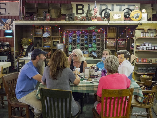 Elvis Presley at the table at Pucketts, Leiper’s Fork near Nashville