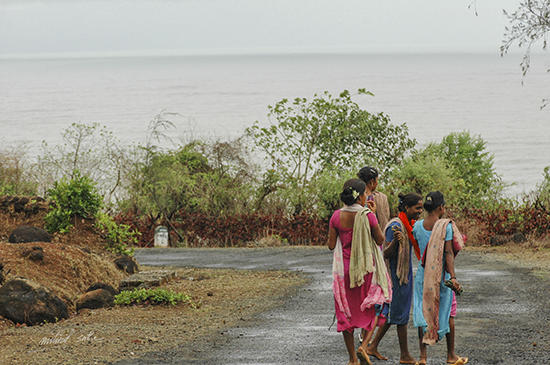 Women on a coastal road in Kokan