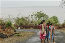Women on a coastal road in Kokan